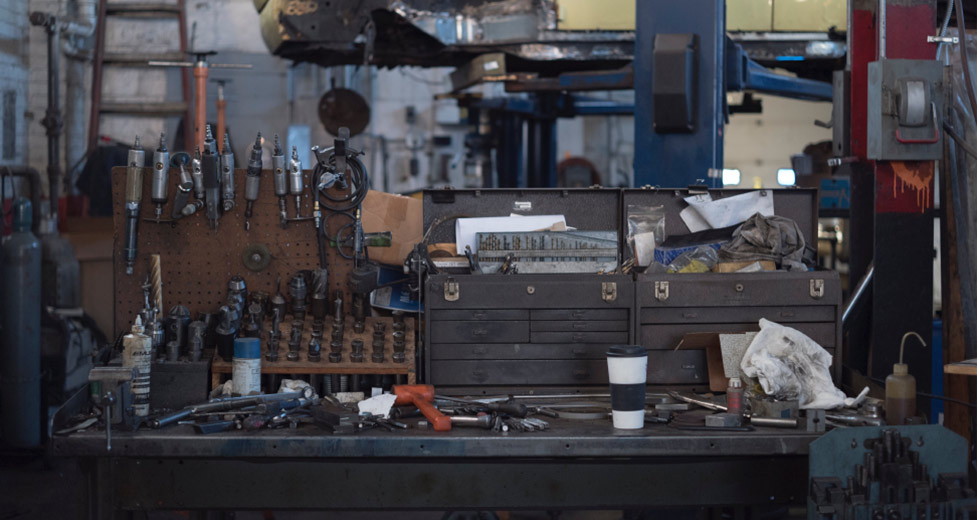 Photo of a workshop with tools and a coffee cup on a work bench. Visit Powell Quality of Life