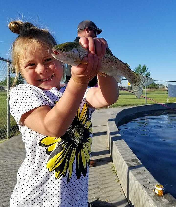 Photo of little girl holding a fish at Homesteader Park Four Seasons of Outdoor Recreation