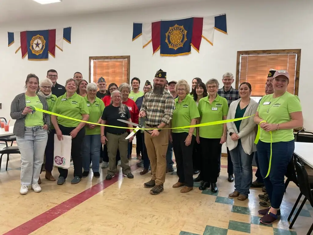 Powell Ambassadors celebrating at a ribbon cutting ceremony at the Powell American Legion Post